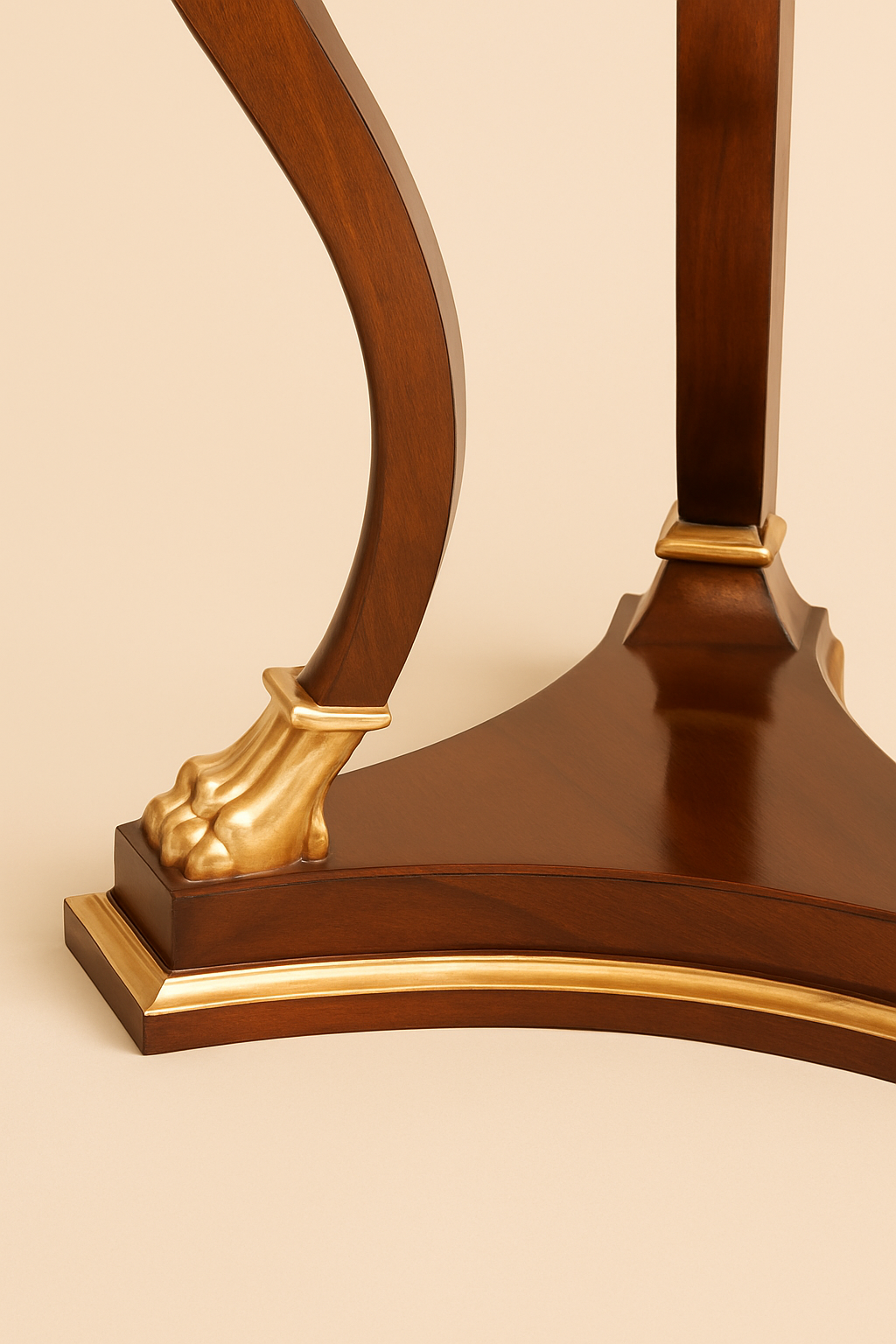 Luxury mahogany side table close-up showing gilded lion paw foot and Regency-inspired curved leg detail