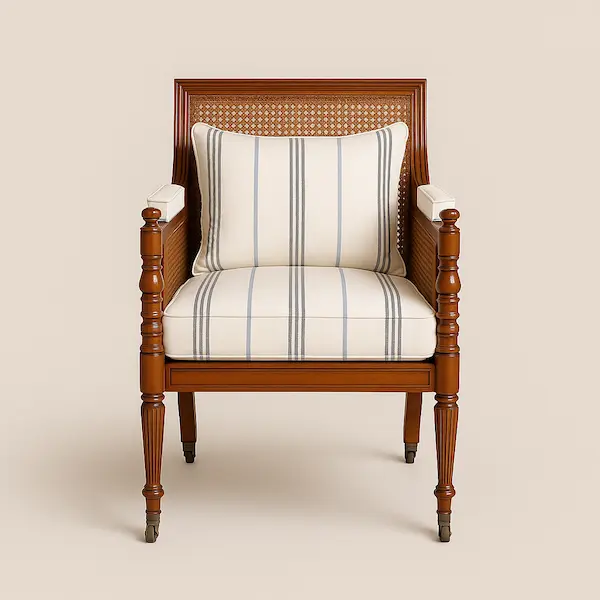 Front-facing view of a luxury wooden armchair with cane backrest and striped cushions