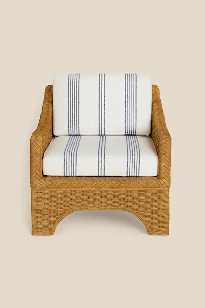 Westport Wicker Lounge Chair with handwoven natural wicker frame and white cushion featuring navy blue stripes.