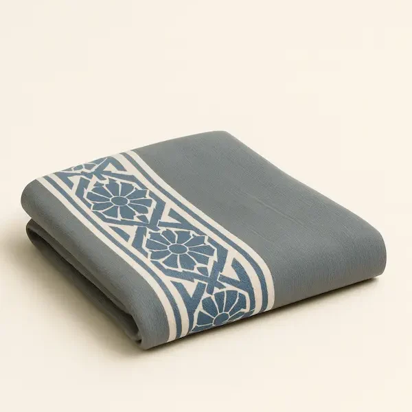 Devonshire Geometric Cotton Throw in slate blue and ivory with gradient gray center panel, woven jacquard design, and finished hem.