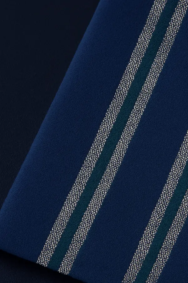 Close-up of woven stripe cotton blanket brushed finish fabric in navy with white stripes