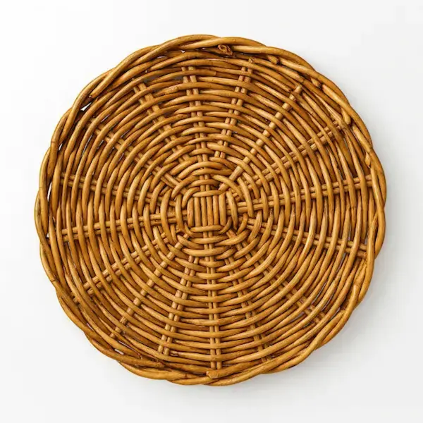 Rattan charger plate on white background – handcrafted dining accent from Reeva Sethi Home, part of our luxury dining collection featuring rattan trays, mahogany trays, and heirloom tableware.