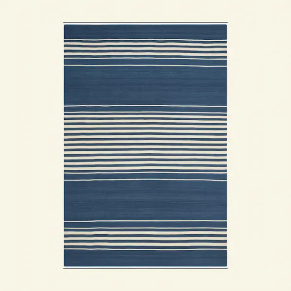 Top-down view of navy and ivory regatta stripe wool flatweave rug with wide and narrow bands